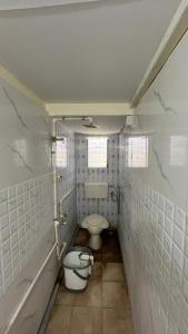 a bathroom with a toilet and a sink at Ritu Holiday Home - Nagaon in Nagaon