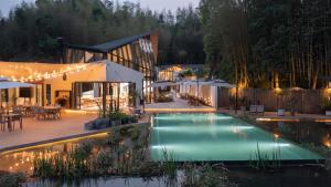 an image of a house with a swimming pool at night at Congxi Creek Resort in Conghua