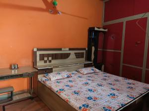 a bedroom with a bed and a desk and a bed sidx sidx sidx at Shri Homestay in Jait