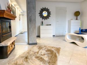 a living room with a fur rug and a fireplace at Ferienwohnung Wohlfühl-Anker in Neuhof