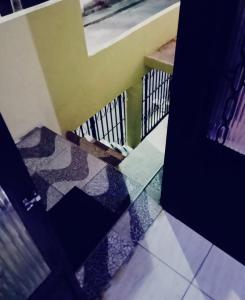 an open door with a tile floor and a staircase at Casa in Fortaleza