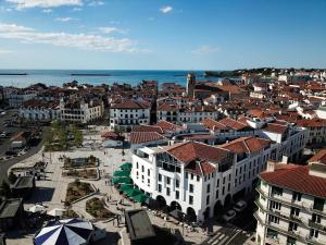 an aerial view of a city with buildings and the ocean at Bizipoz Hôtel in Saint-Jean-de-Luz