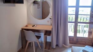 a bathroom with a vanity with a mirror and a chair at Villa Anna Maria in Agia Paraskevi
