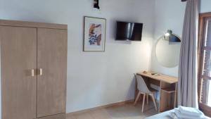 a bedroom with a desk and a mirror at Villa Anna Maria in Agia Paraskevi