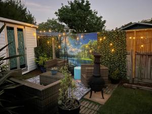 a patio with a wall with a painting of a lake at Kombi Cottage Fully accessible in Tairua