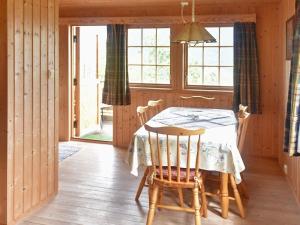 a dining room with a table and chairs at 5 person holiday home in Utvik-By Traum in Reed +9 photos