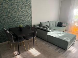 a living room with a couch and a table at Boulevard Apartman in Nyíregyháza
