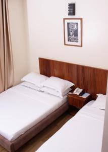 Postel nebo postele na pokoji v ubytování Flamarc Hotel