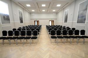 an empty room with black chairs in it at Hotel Gem in Wrocław