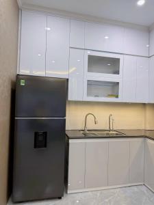 a kitchen with a refrigerator and a sink at CAT BA Villas 5 Rooms in Cat Ba +13 photos