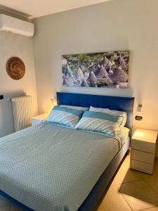 a bedroom with a bed with a painting above it at Puglia Suite in Casamassima