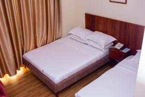 Postel nebo postele na pokoji v ubytování Flamarc Hotel