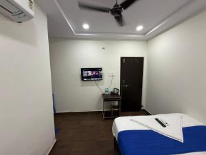 Camera con letto e TV a schermo piatto. di COCO NET Hotel a Ibrāhīmpatan Altre 37 foto