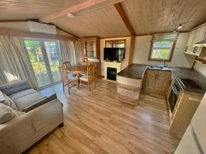 a kitchen and living room with a couch and a table at Camping Bungalows Sol D´Or in Peniscola