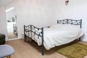 a bedroom with a bed and a mirror and a chair at L'écurie in Floirac