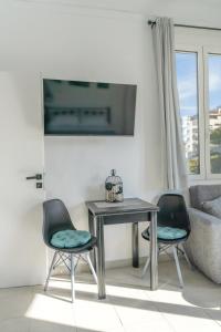 a living room with a table and two chairs at Chrysi Guesthouse in Rethymno +7 photos
