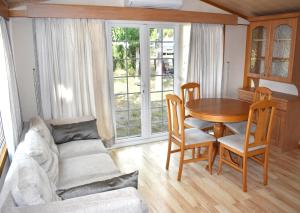 a living room with a table and chairs and a couch at Camping Bungalows Sol D´Or in Peniscola