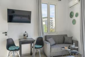 a living room with a couch and two chairs at Chrysi Guesthouse in Rethymno