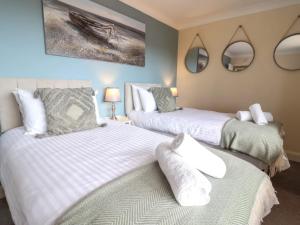 Voodi või voodid majutusasutuse Seascape Cottage toas