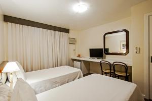 Postel nebo postele na pokoji v ubytování Trevi Hotel e Business