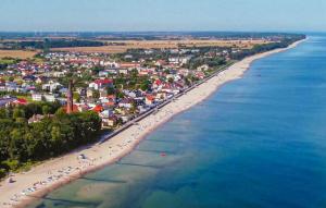 an aerial view of a beach with a crowd of people at Awesome Home In Sarbinowo in Sarbinowo +19 photos