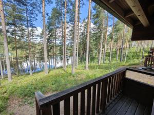 a porch of a cabin with a view of the woods at Ahvenlampi Camping Hostel in Saarijärvi