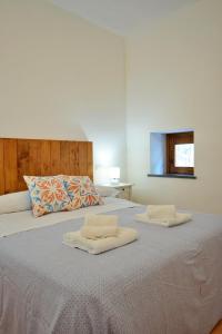 a large bed with two towels on top of it at Casa della Marina - beach, seaview, wifi in Conca dei Marini