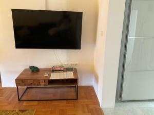 a living room with a coffee table and a flat screen tv at Vila Fjaka in Dugi Rat