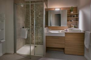 a bathroom with a shower and a sink at Résidence Services Seniors DOMITYS - Les Galopins in Trélissac +2 photos