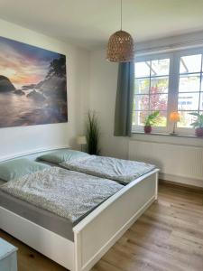 a bedroom with a bed and a painting on the wall at Wohnen im Stielwerk in Munster