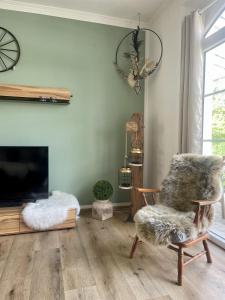 a living room with a chair and a fireplace at Wohnen im Stielwerk in Munster im Heidekreis