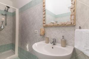 a bathroom with a sink and a shower and a mirror at La Dimora Di Montelittu With AC - Happy Rentals in Loiri
