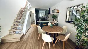 a kitchen and dining room with a wooden table and chairs at Casa en el centro , con amplia terraza in Vinarós