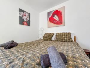 a bedroom with a bed with red lips on it at Appartement 2 chambres - Arrivée autonome - Wi-Fi Fibre in Bruay-la-Buissiere