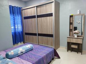 a bedroom with a bed and a large closet at By The River Homestay in Kuala Perlis