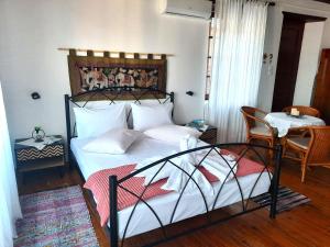 a bedroom with a bed and a table and chairs at Adamantia's Home in Glossa