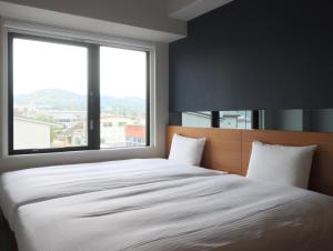 Postel nebo postele na pokoji v ubytování Hotel Glad One Kyoto Shichijo by M's