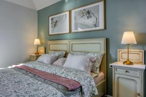 a bedroom with a bed with two pictures on the wall at VILLA PRISUNAC - private luxury with amazing sea view between Istria and Kvarner in Zagorje +41 photos