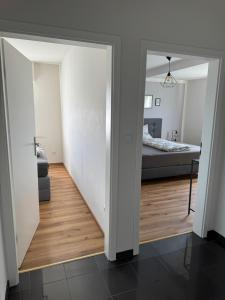 a hallway leading to a bedroom with a bed at Ferienhaus Hunsrückliebe in Liederbach +62 photos