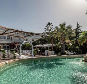 a large swimming pool in front of a building at Hotel La Rosa Dei Venti in Campogrande