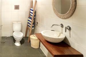 a bathroom with a sink and a toilet at Twin Palms Villa and Homestay in Tuapejat +15 photos