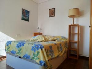 a bedroom with a bed with a colorful blanket at La casa de las golondrinas in Tángel