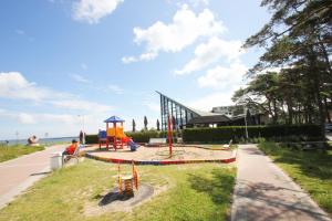 a park with a playground with a slide at Ferienhaus Strandfeeling Glowe in Glowe
