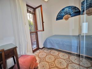 a bedroom with a bed and a glass door at Casa Camillo Piana Ovest in Lerici