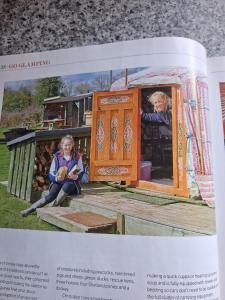 a magazine article with a picture of two people in a house at Glamping West Midlands in Enville