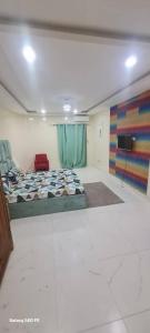 a room with a bed and a television in it at Natale immo in Dakar +2 photos