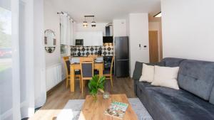 a living room with a couch and a table at Baltic Line - Sobieszewski Raj in Gdańsk