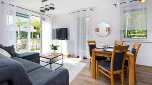 a living room with a couch and a table at Baltic Line - Sobieszewski Raj in Gdańsk