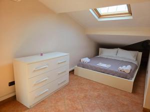 a small bedroom with a bed and a dresser at Express Sleep Fiumicino Airport in Fiumicino