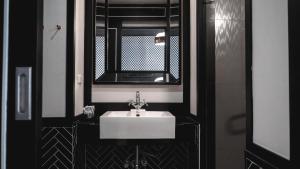 a bathroom with a white sink and a mirror at Sugar Marina Hotel - FASHION - Kata Beach in Kata Beach